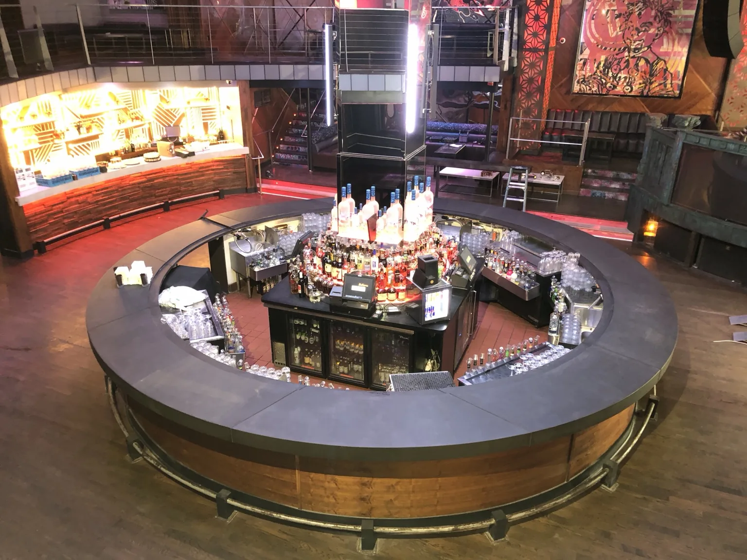 Large round commercial bar with dark concrete countertop